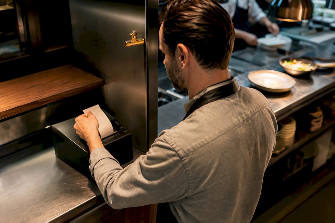 Manager receiving an online restaurant order ticket