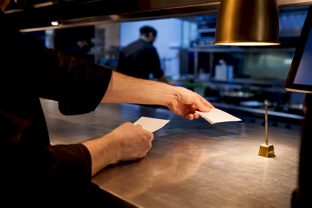 Expediter routing delivery orders to kitchen stations