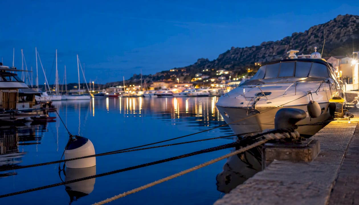 Suggestiva vista serale sul porto turistico di Cannigione, illuminato dalle luci degli yacht ormeggiati.