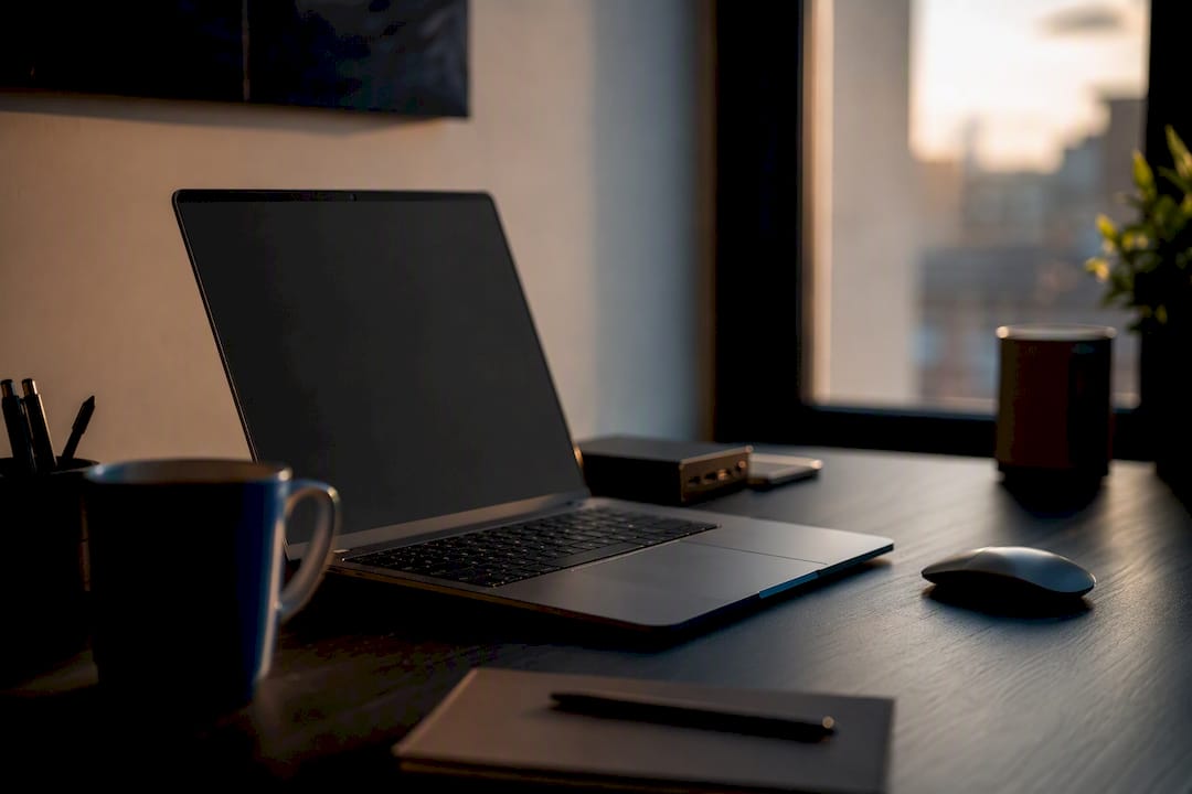 Developer workspace with dark screen and tech desk items