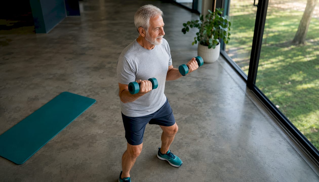 Senior man lifting dumbbells exercising