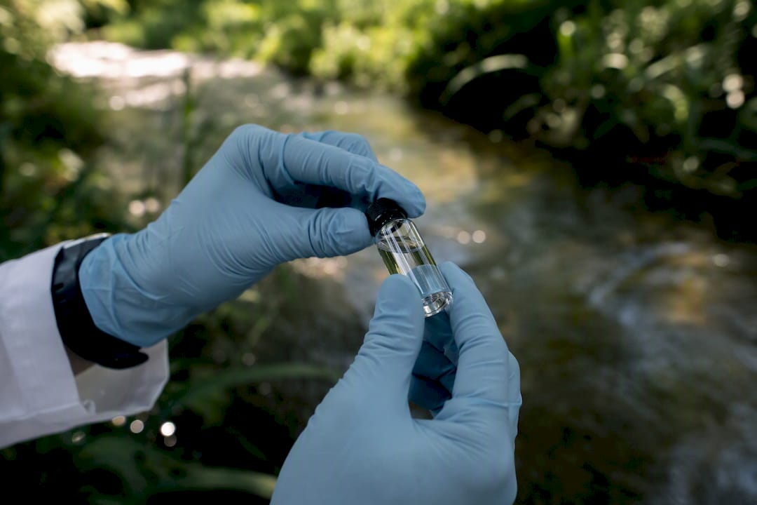 Hands holding vial in lab setting