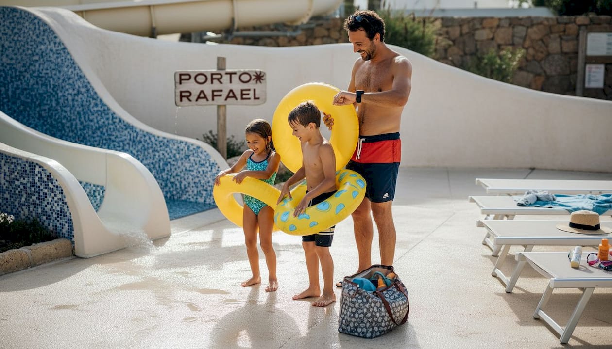 Family waiting by Sardinian water slide