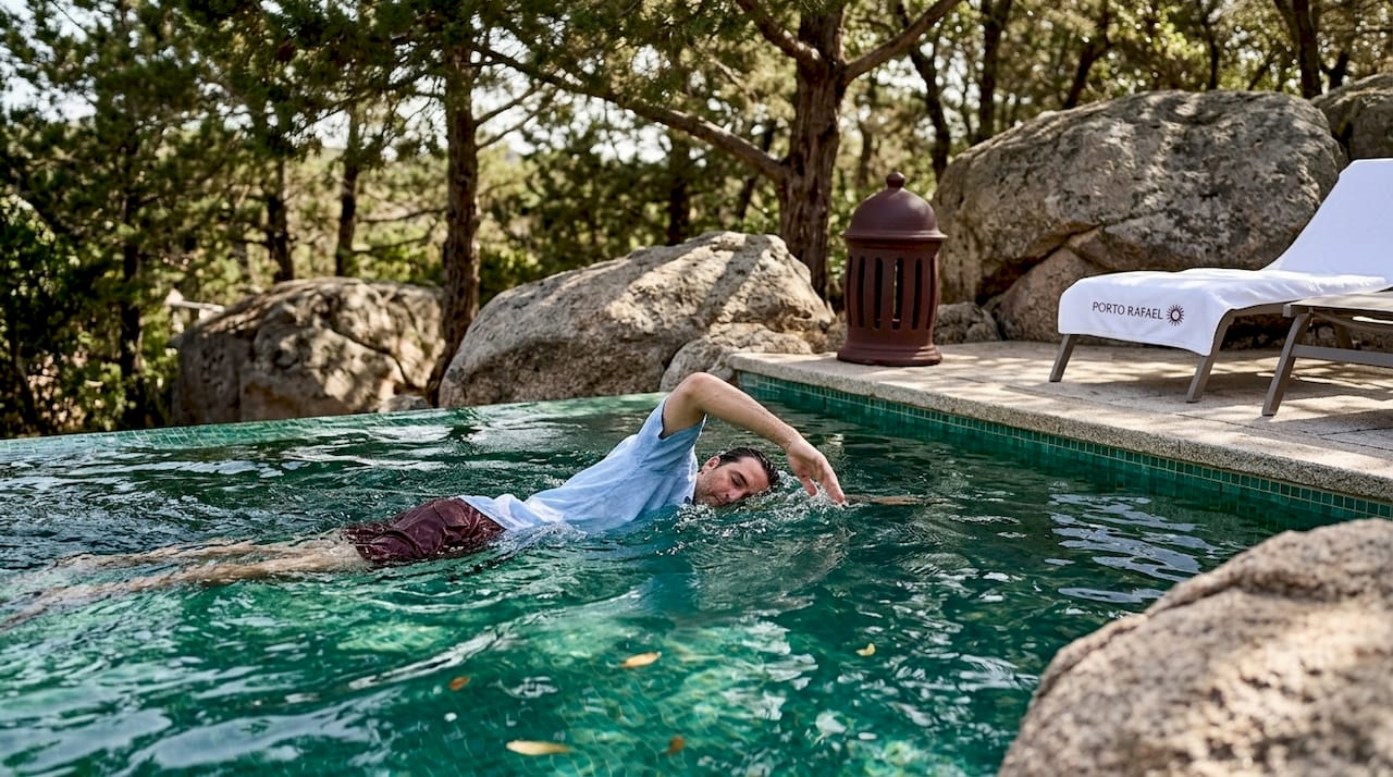 Guest swimming in boutique resort pool