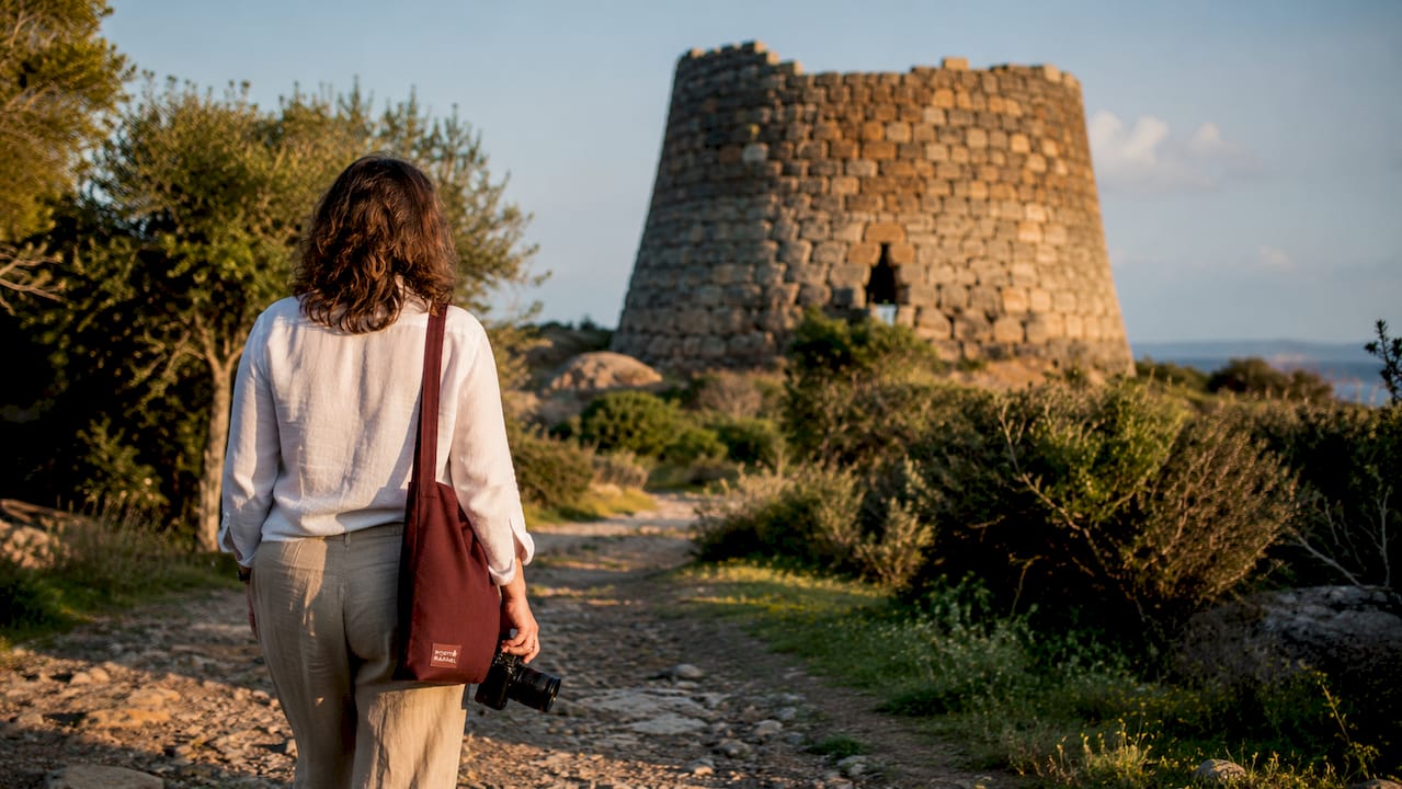 Tourist approaching Nuragic tower path