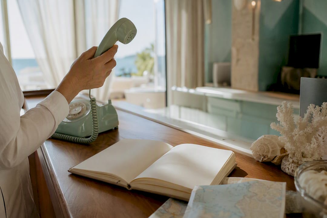 Concierge hand confirming booking on phone
