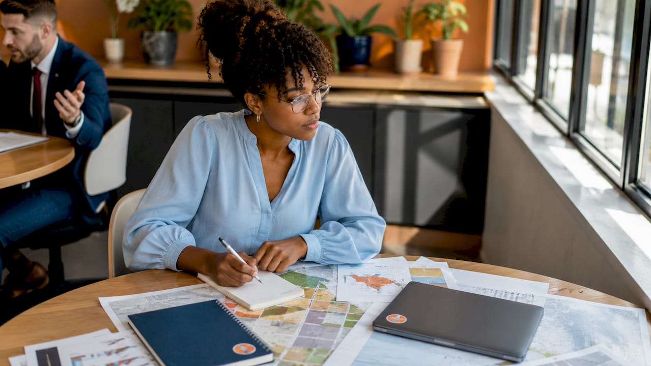 Urban planner reviewing zoning maps in office