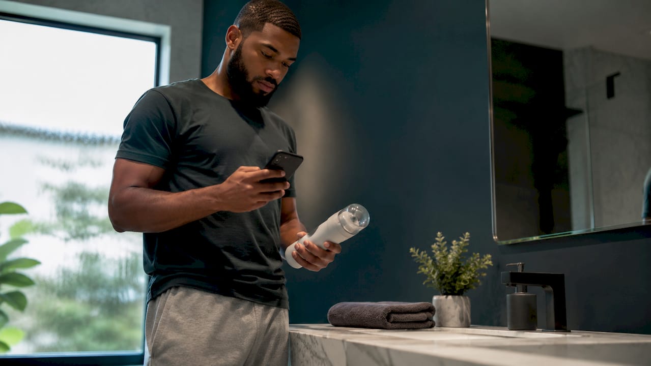 Man using intimate health device at home