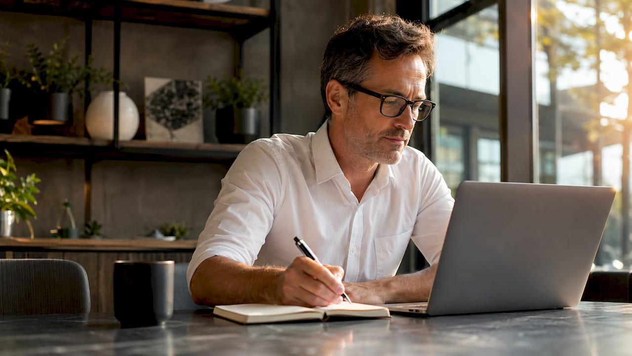 Man using online sexual well-being guide in home office