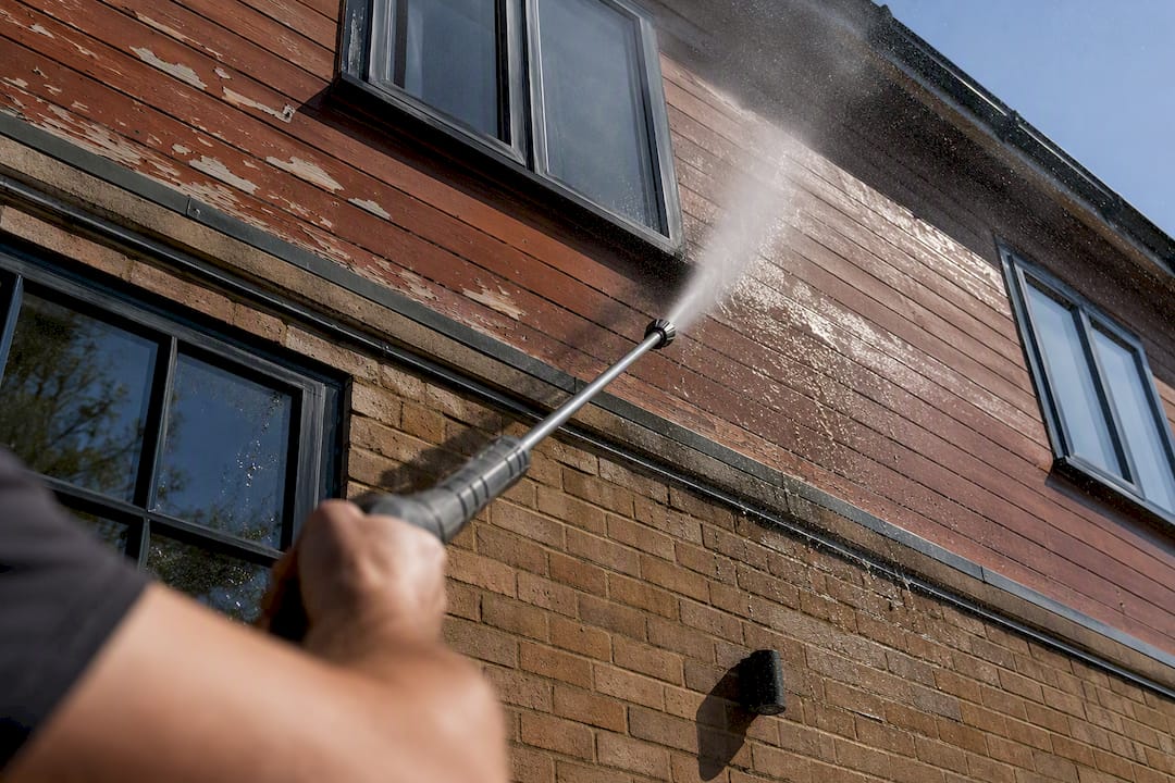 Power washing dirt from house exterior