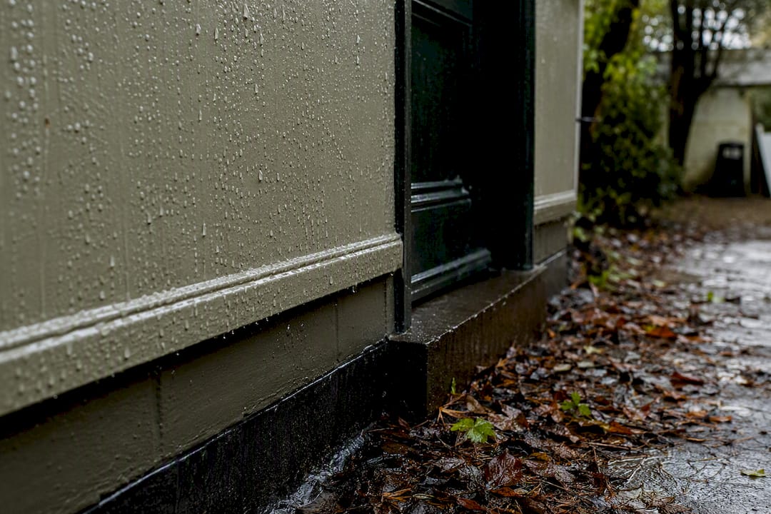 Wet exterior wall paint after rain