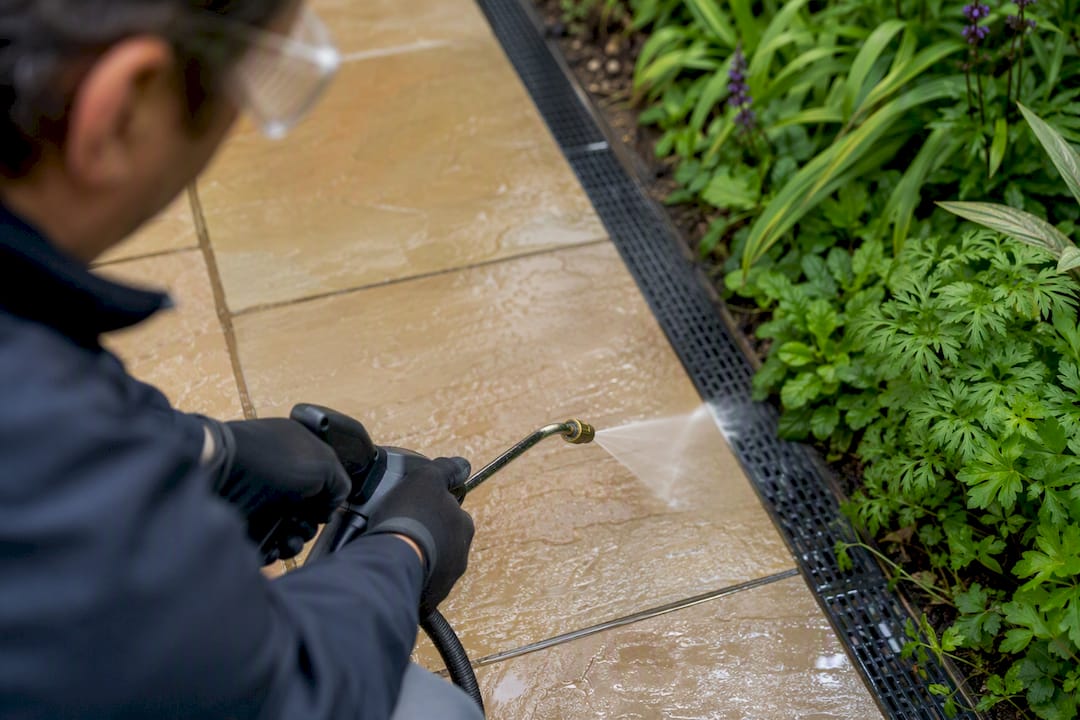 Protected hands soft washing patio safely
