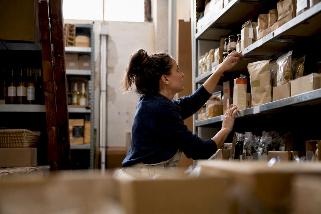 Retailer arranging products on shelves