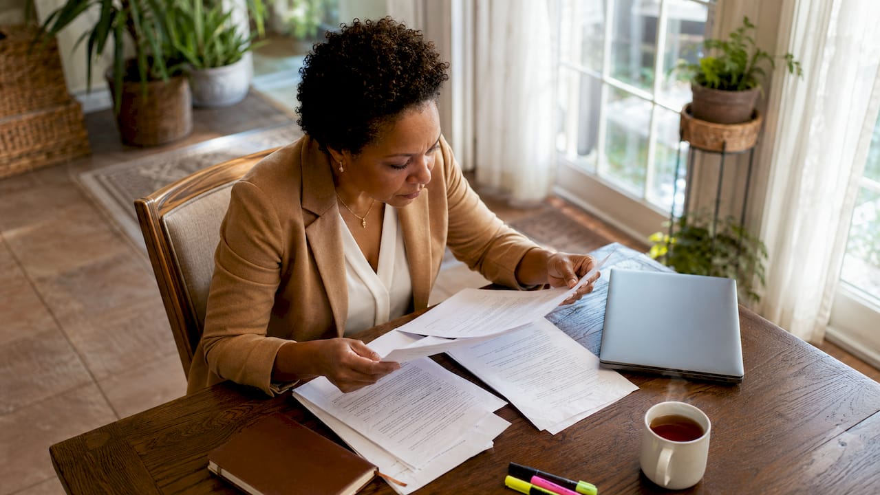 Woman reviewing whistleblower legal documents at desk