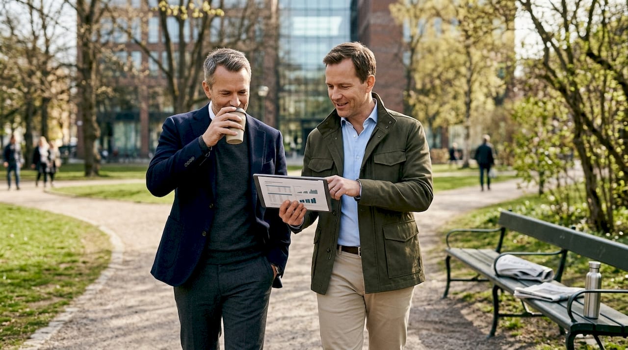 Executives discuss business while walking outdoors