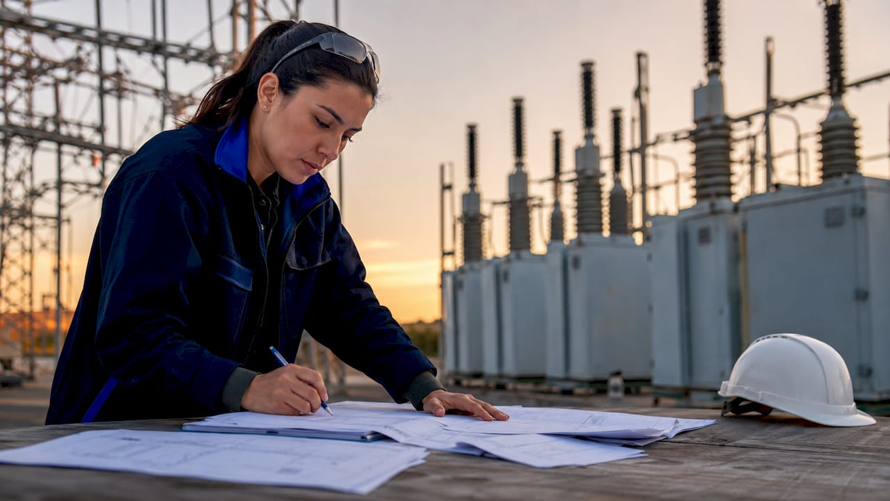 Engineer reviewing surge protection assessment indoors