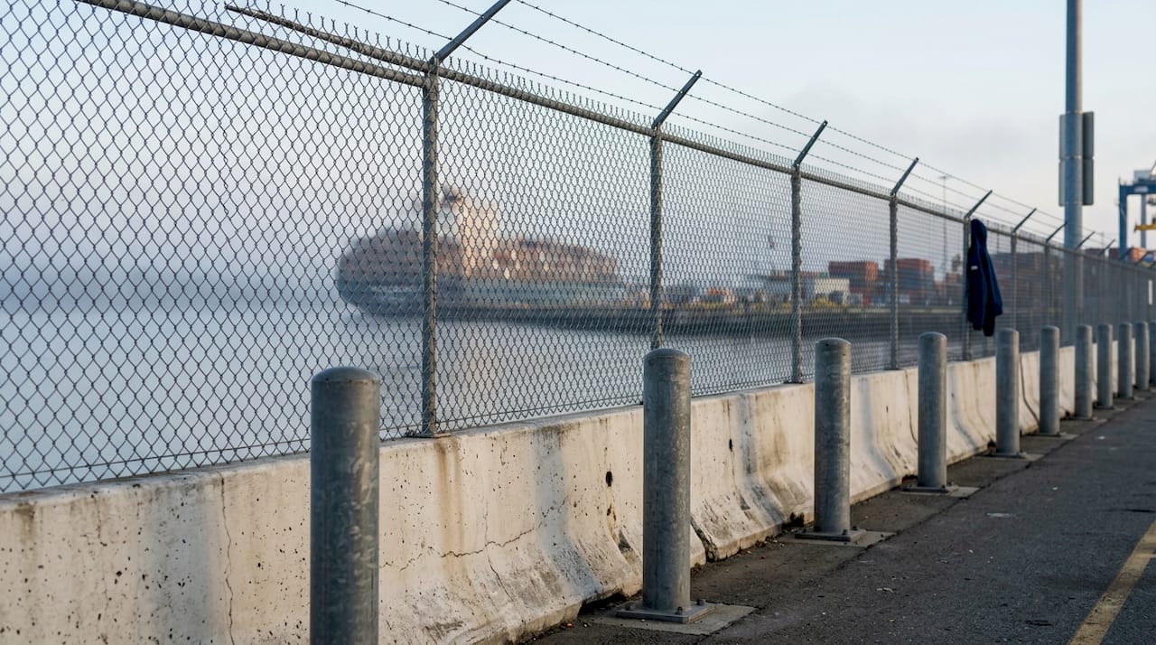 Close-up of bollards and port fence perimeter