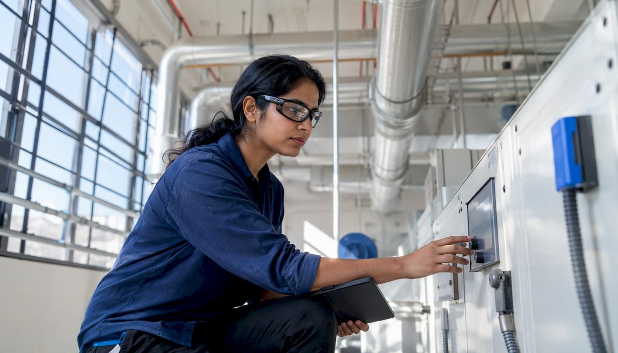 HVAC engineer adjusting ventilation system