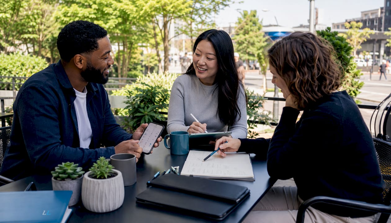 Team planning LinkedIn marketing content in café