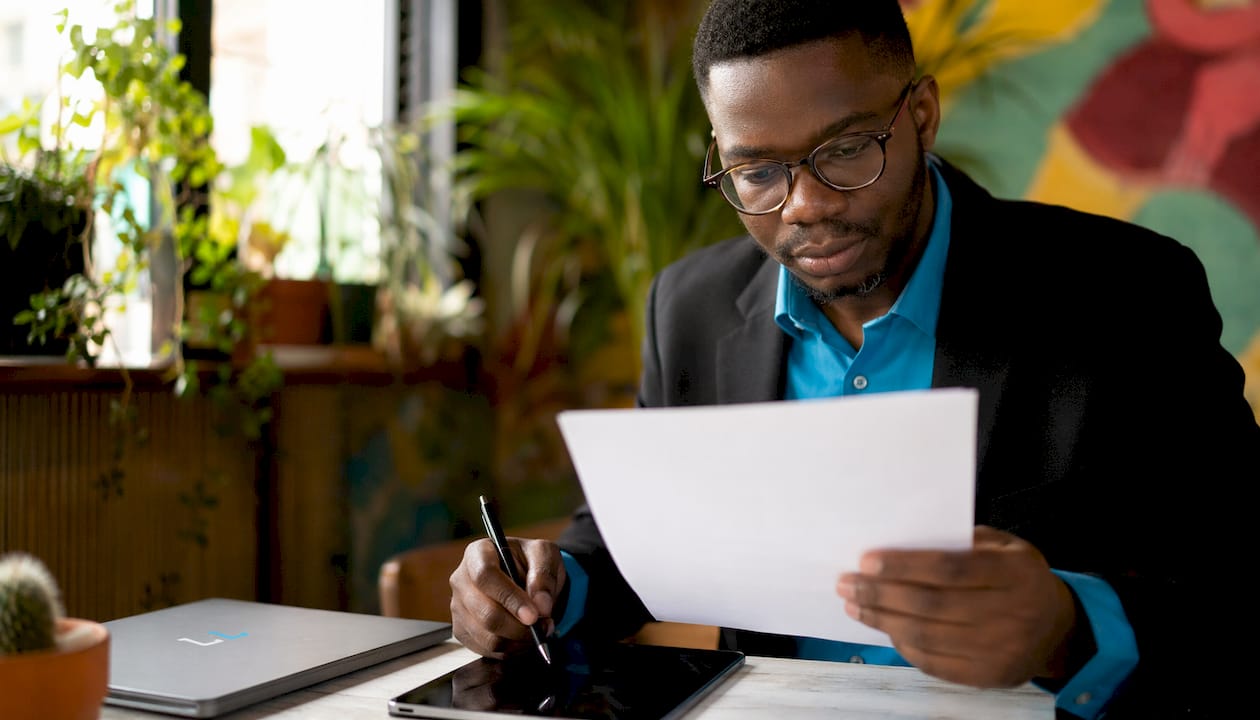 Man reviewing job posting to personalize email greeting