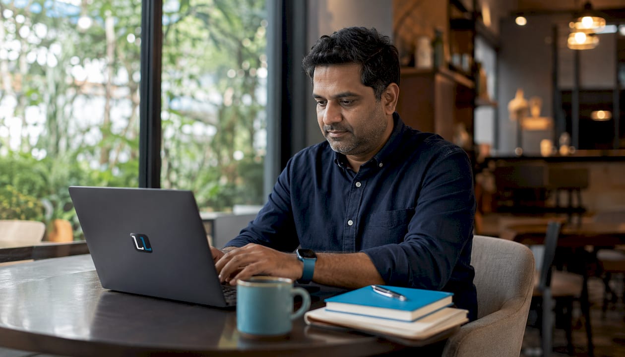Hands typing on laptop in sales training context