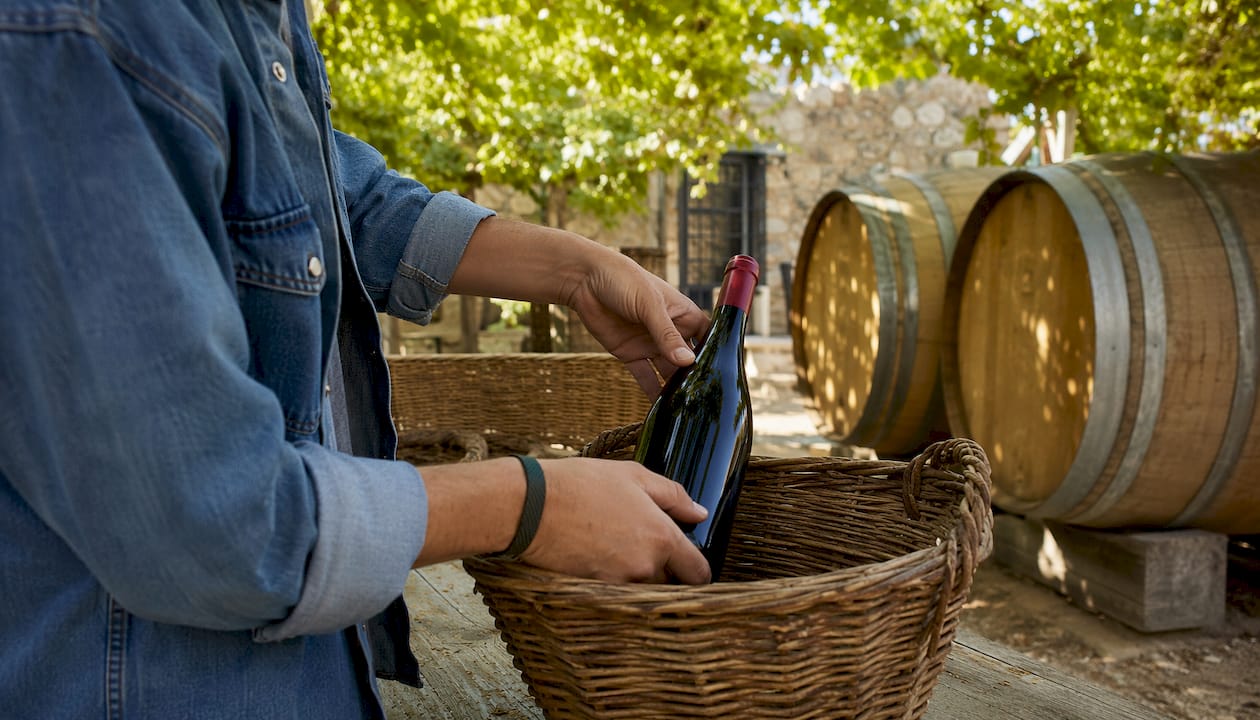 Hands packing niche wine bottles