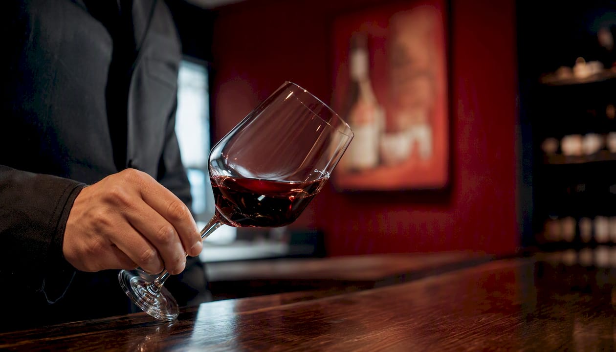 Hand swirling wine glass for aroma assessment