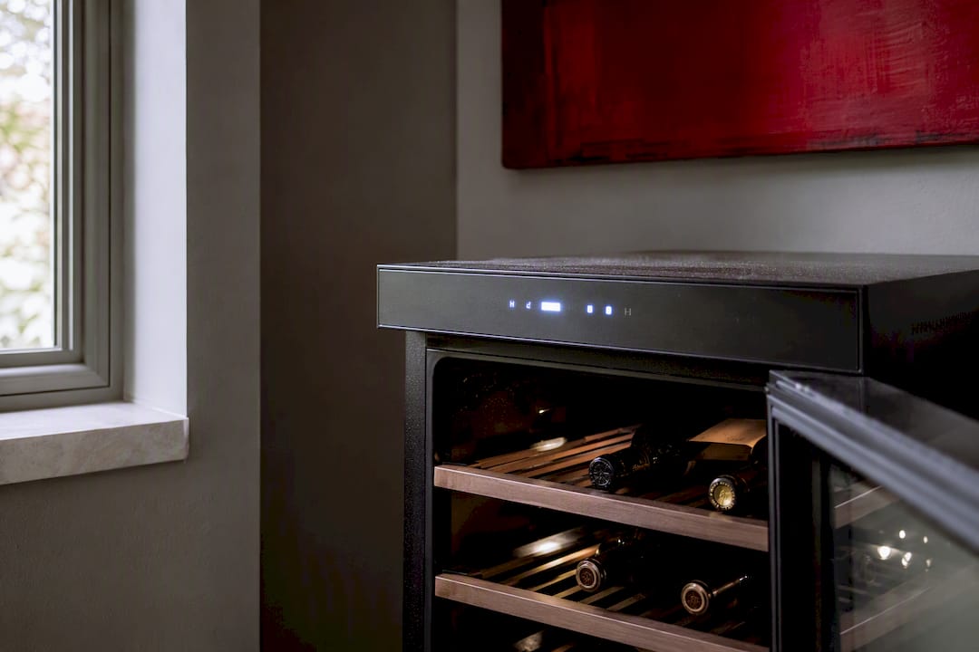 Compact wine fridge in stable home cellar corner