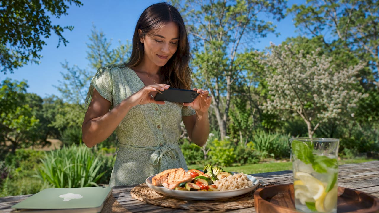 Woman photographing meal for nutrition analysis