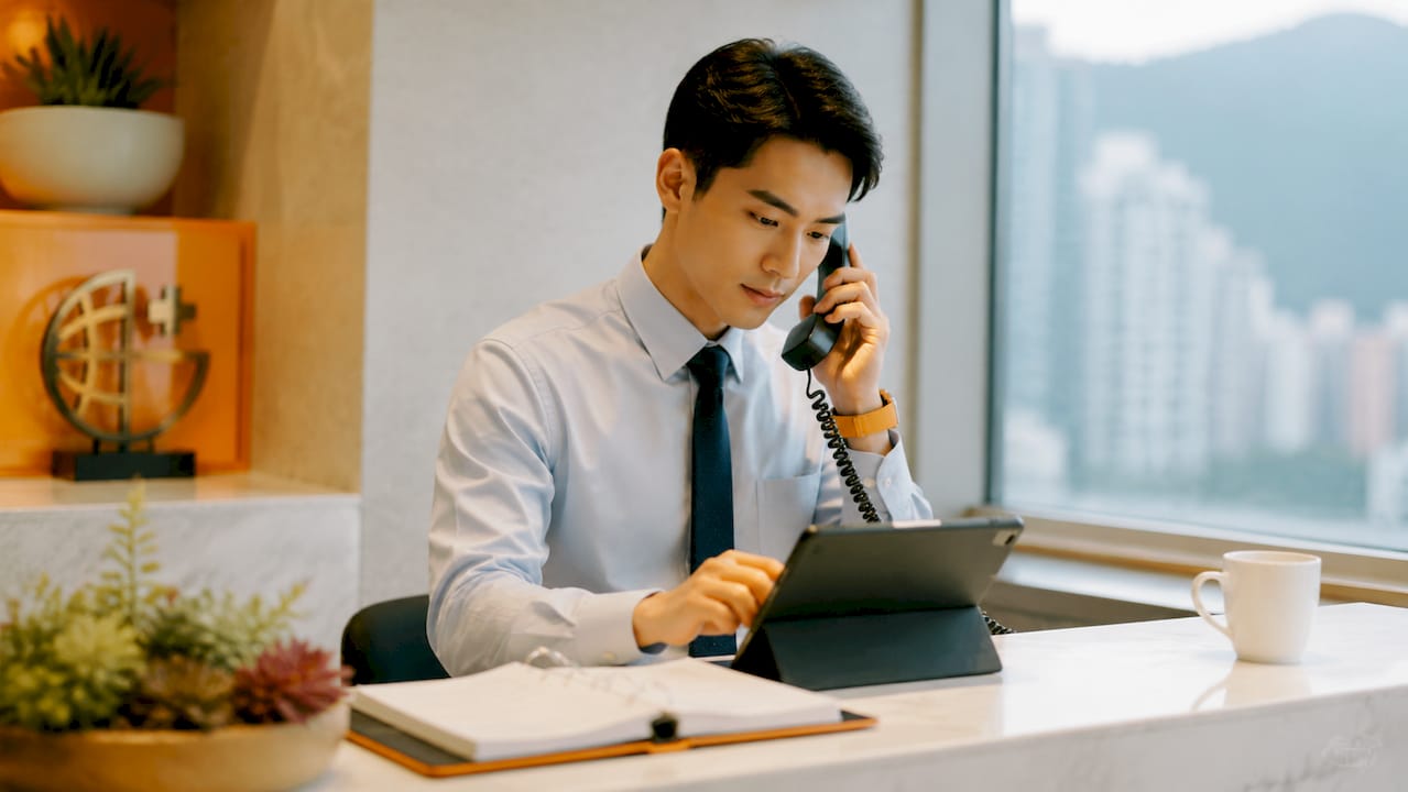 Receptionist managing bookings at clinic reception
