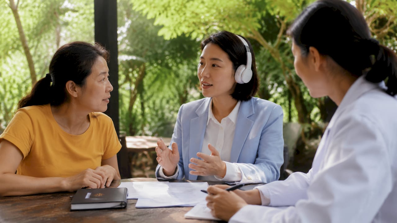 Bilingual medical consultation with interpreter and patient