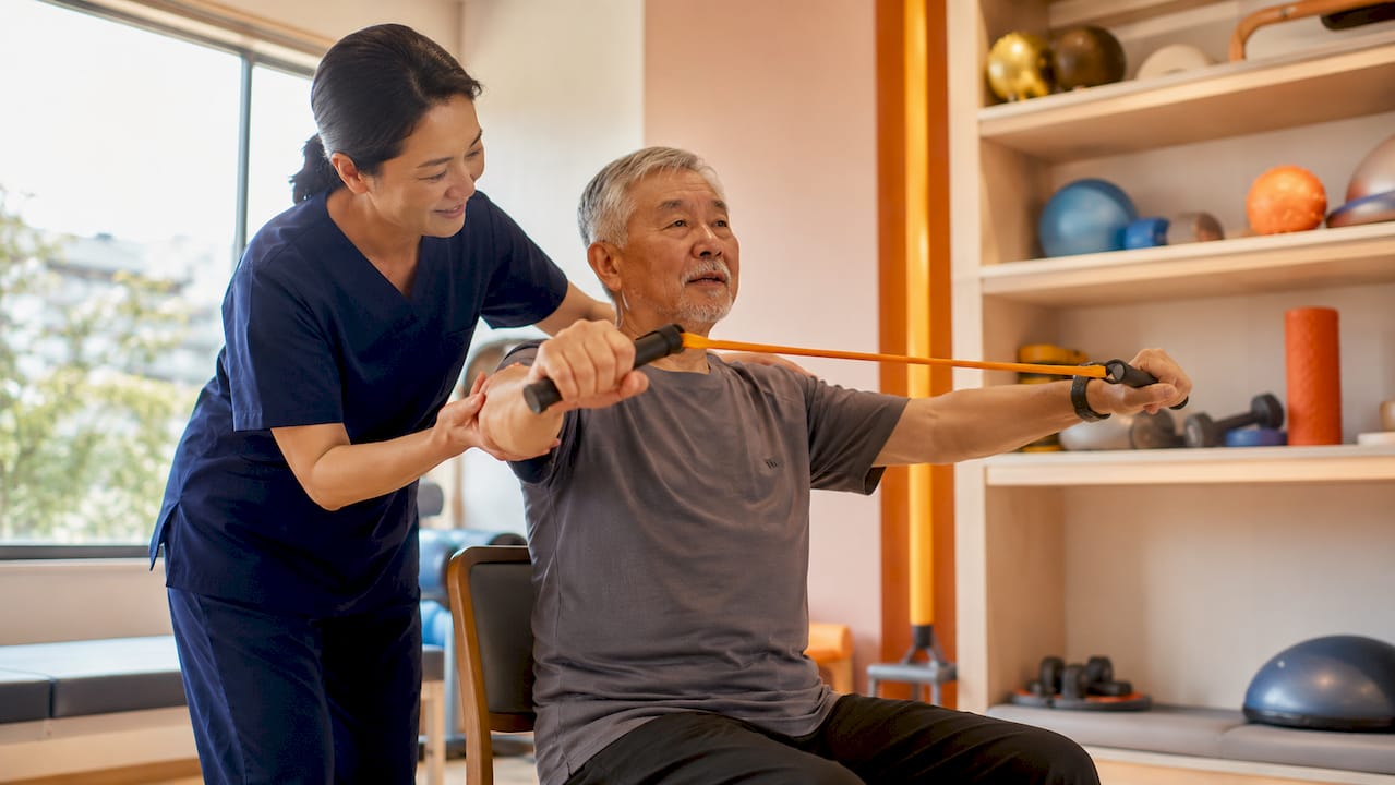 Physiotherapist guiding patient exercise in clinic