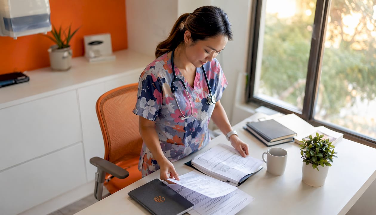 Nurse reviewing patient files in outpatient clinic