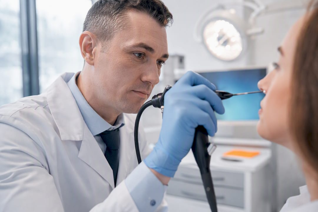 ENT clinician performing sinus endoscopy examination