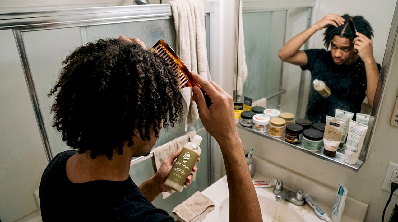 Man caring for different hair textures in bathroom