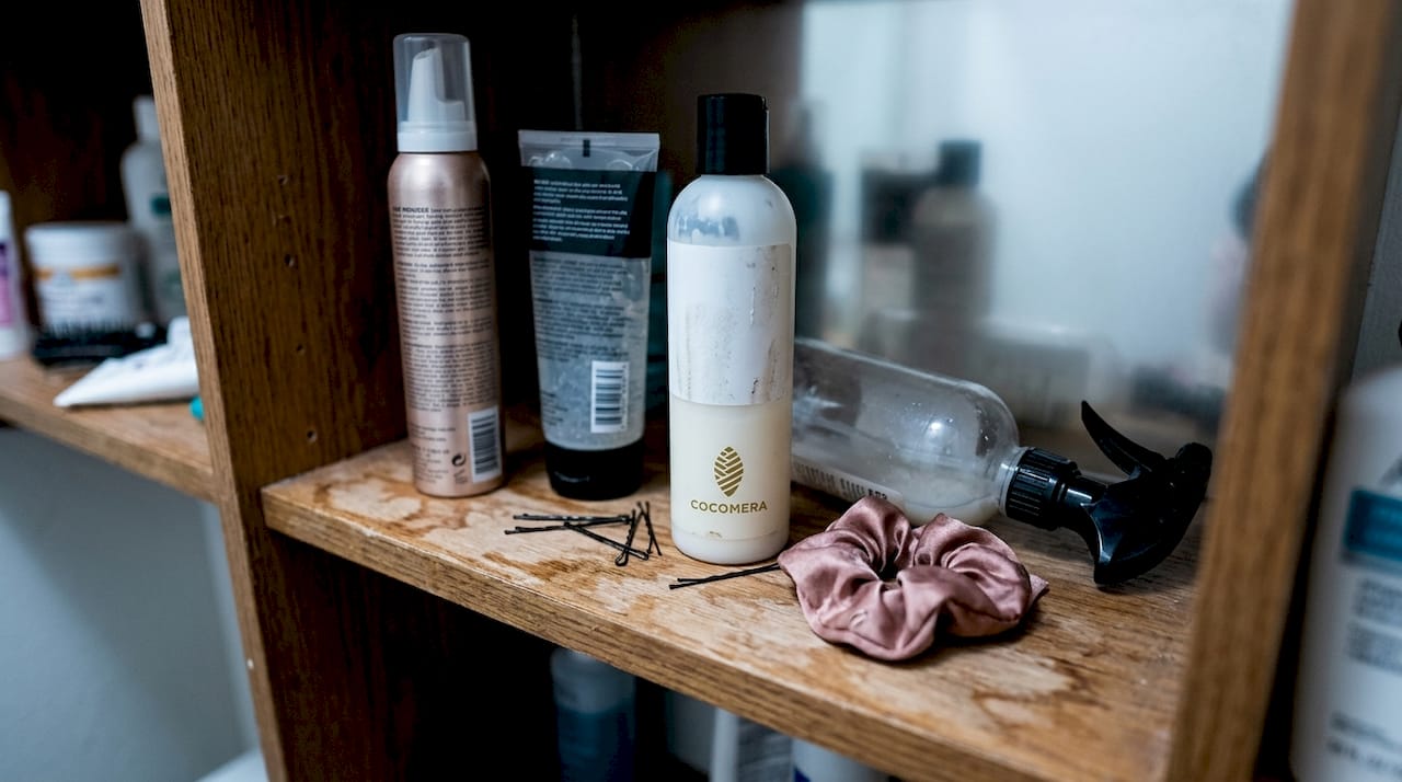 Lightweight hair products on bathroom shelf