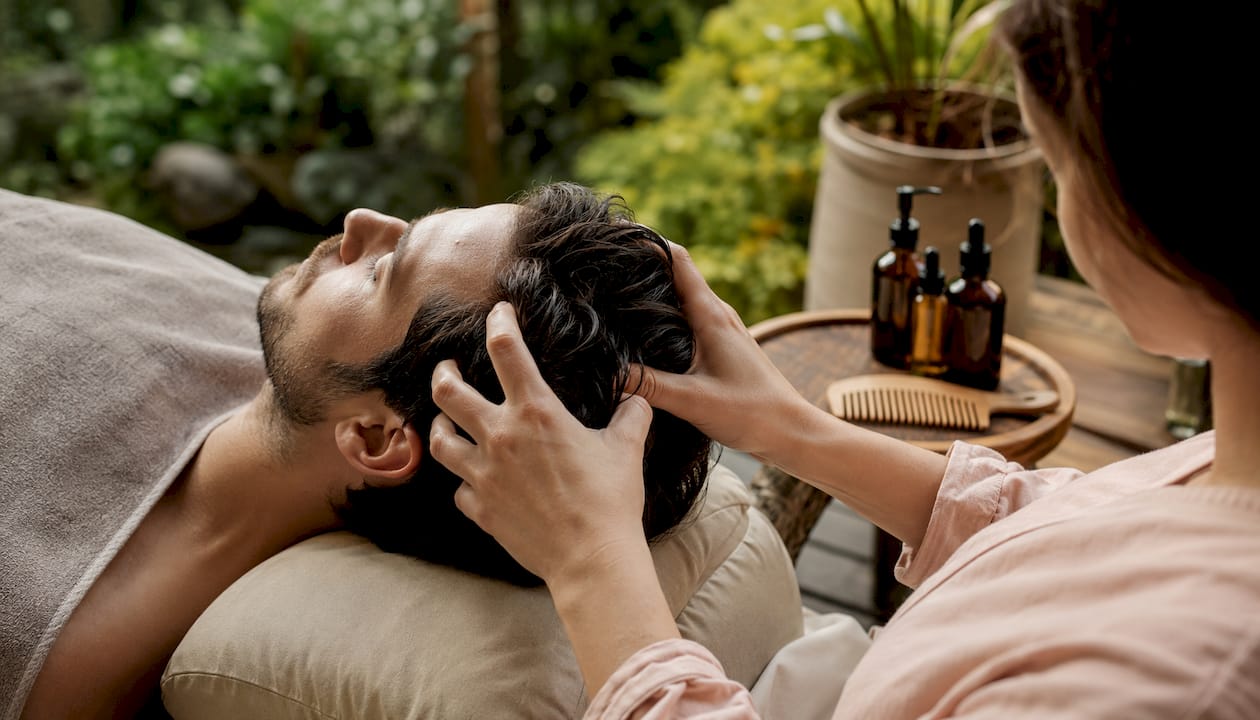 Overhead hands massaging scalp nape and sides