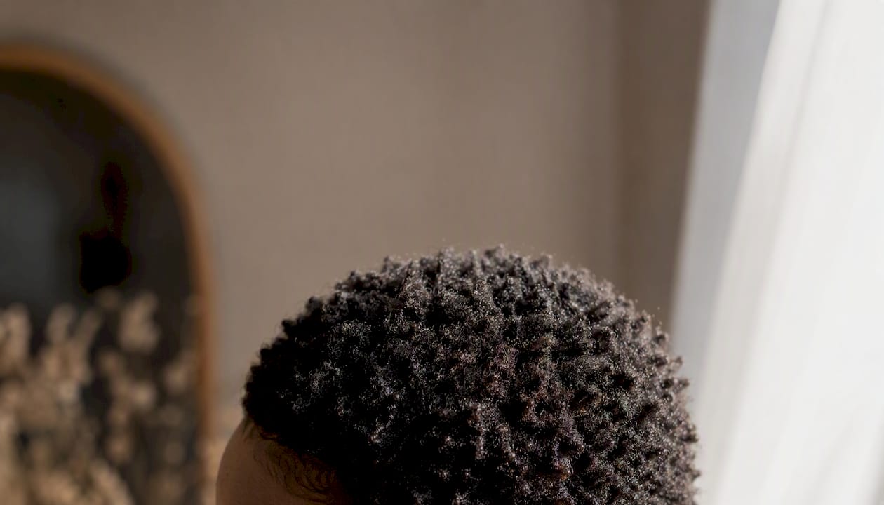 Close-up of tight natural curls in teeny-weeny afro style
