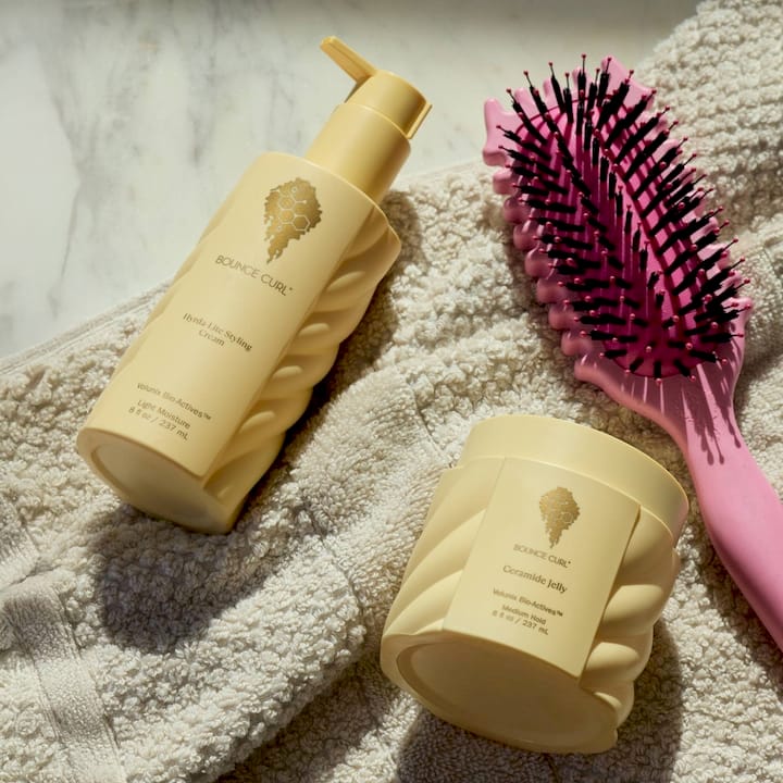 Woman deciding between curl creams