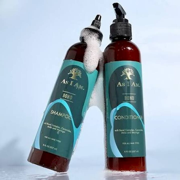 Person smoothing frizz from curls on humid day