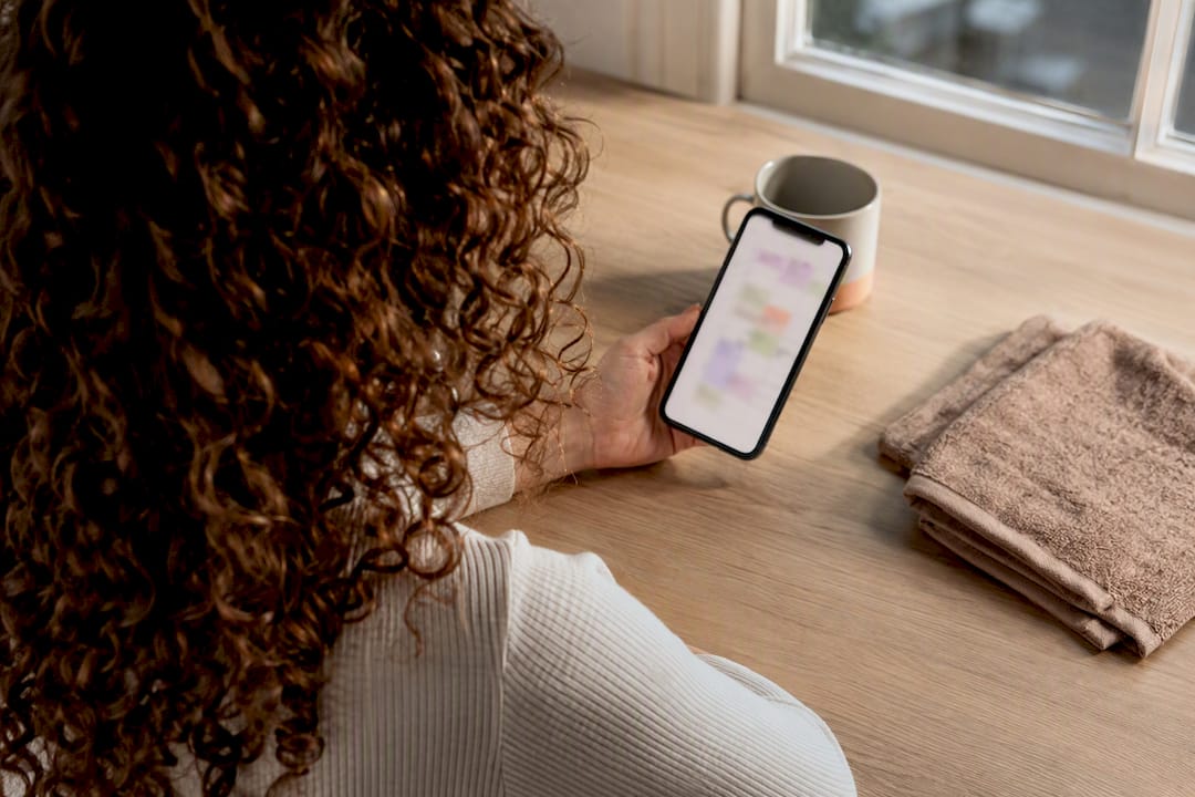 Woman tracking curly hair wash days