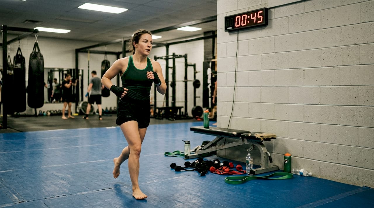 Master the key components of MMA fitness for performance 1 Female athlete sprinting for conditioning