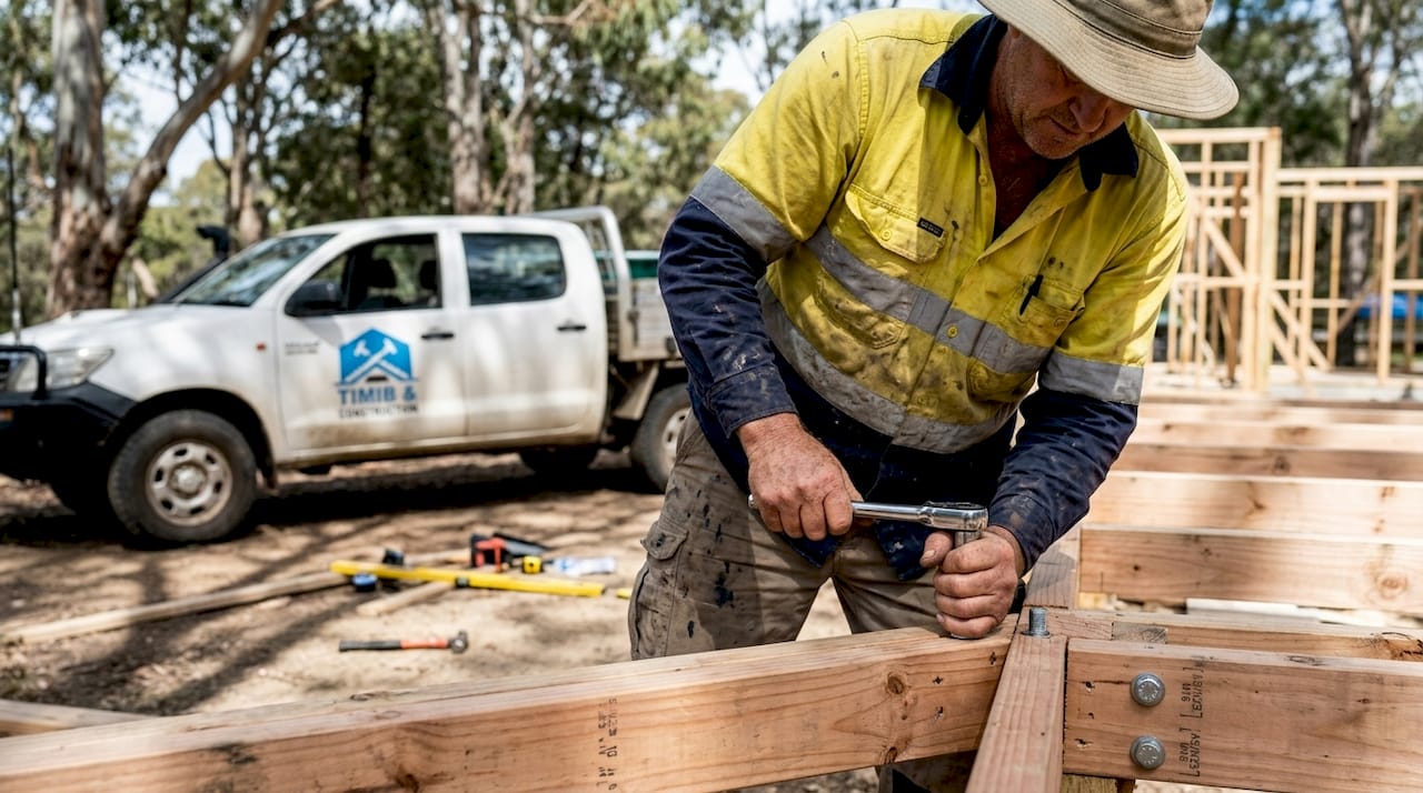 Foreman confirming fastener installation on timber frame