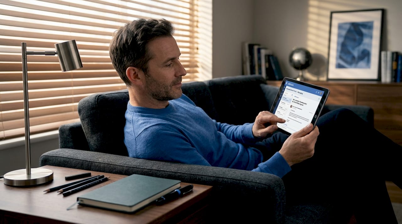 Father interacting with school platform on tablet