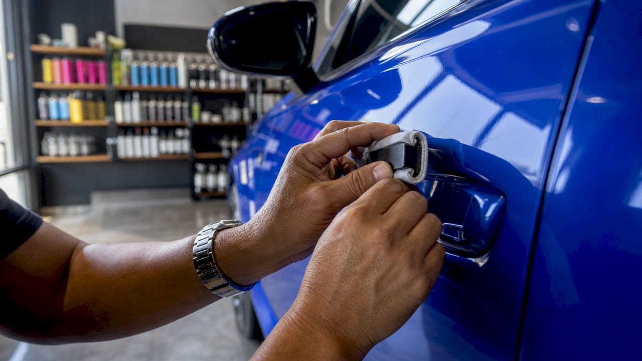 Close-up of hands using magnet for paint inspection
