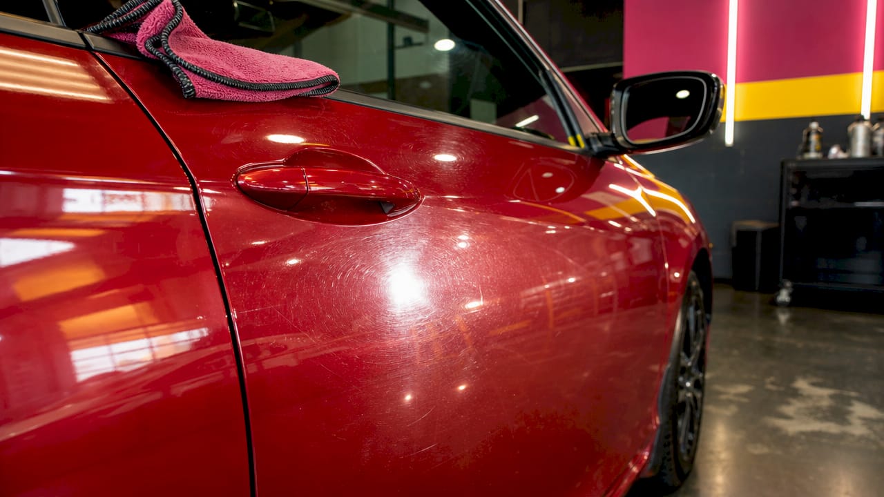 Close-up of car paint swirl marks from waxing