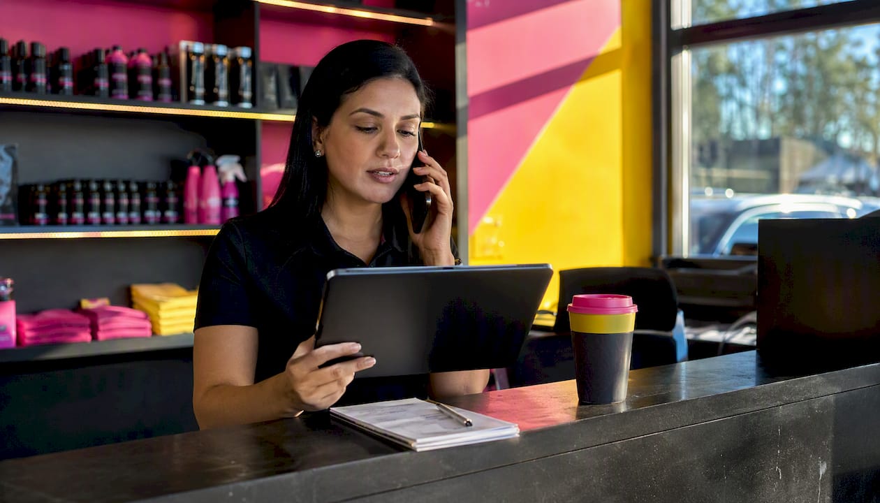 Service advisor on phone at car protection shop desk