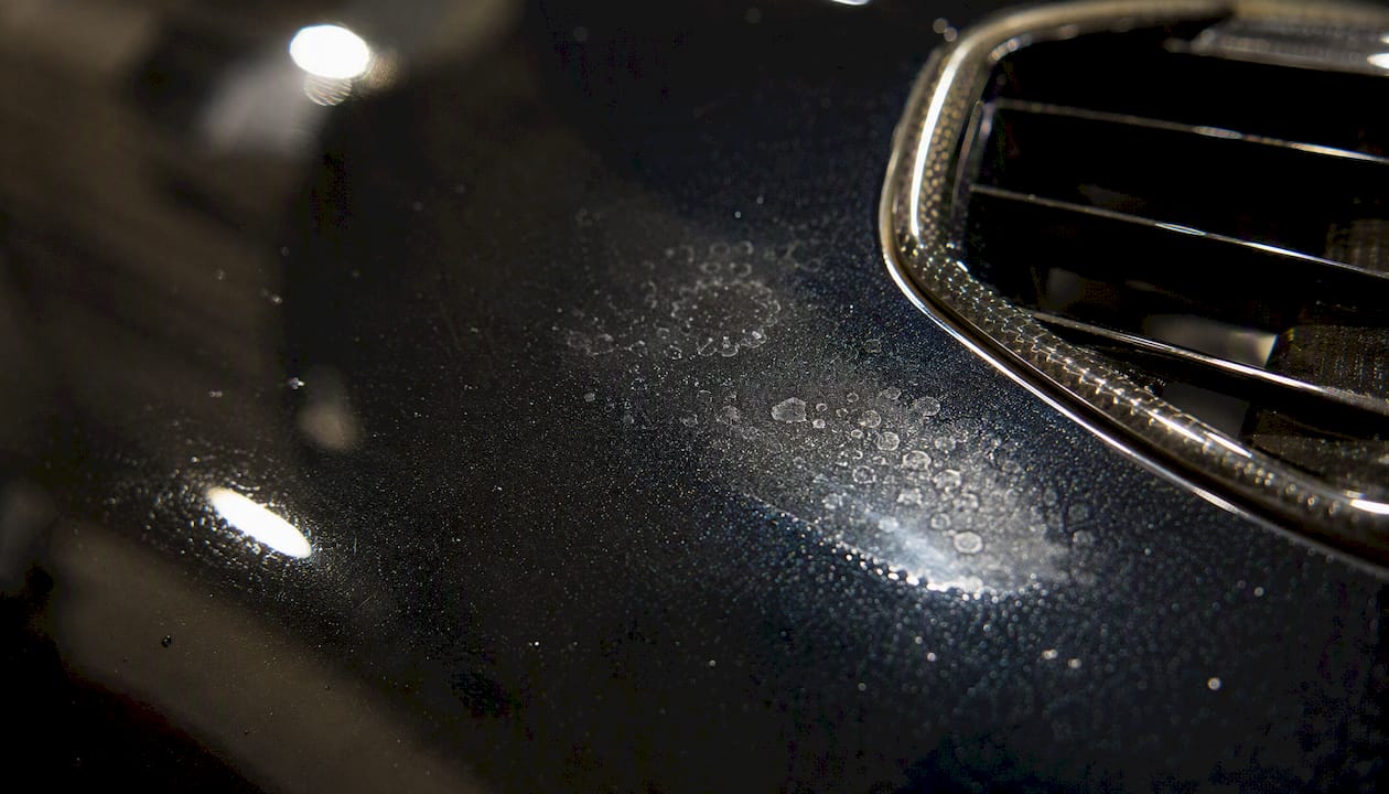 Close-up of subtle acid etching on car paint