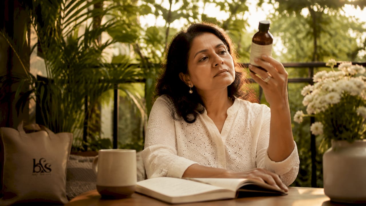 Woman reading skincare product label closely