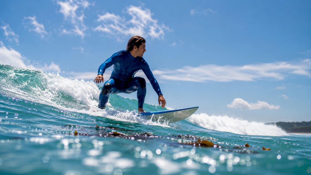 Surfer paddling through ocean waves and currents